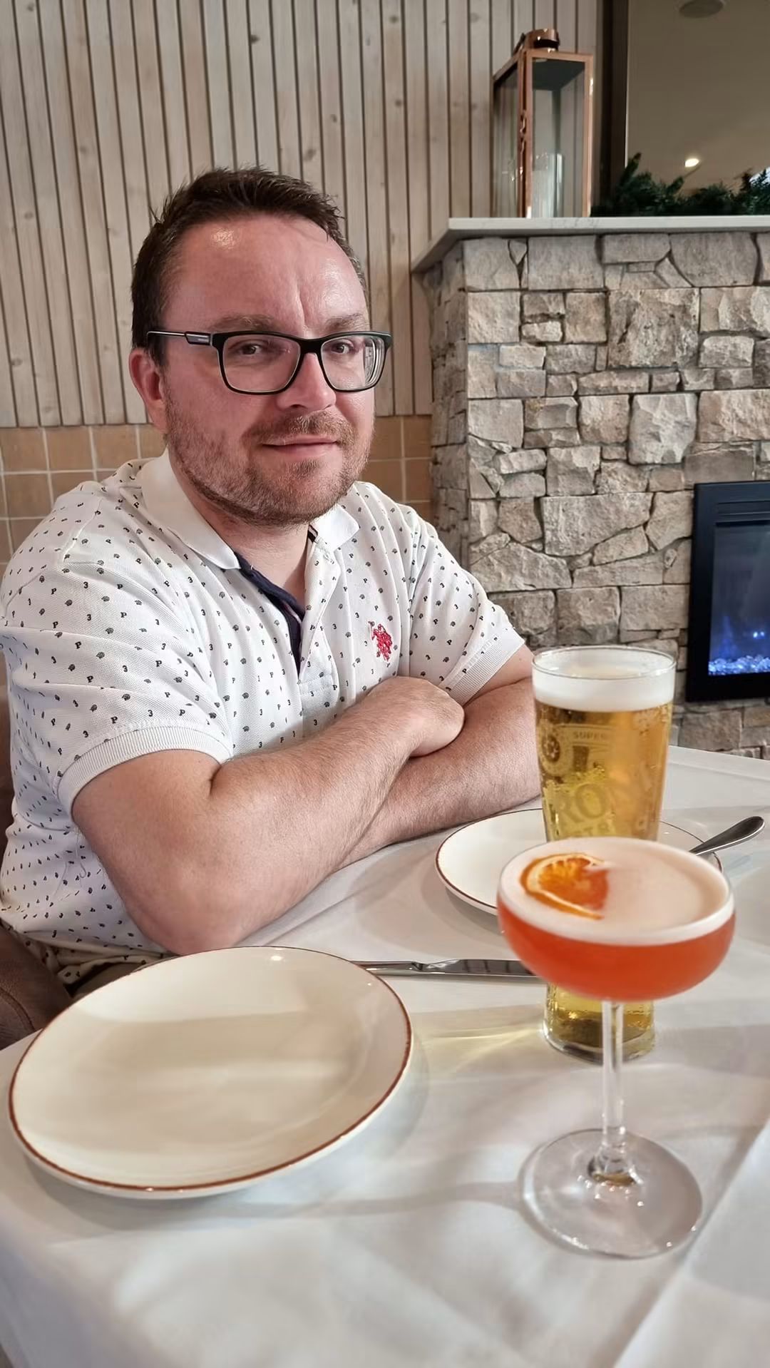Renz enjoying a meal with a beer